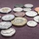 A photo of various coins, aimed at depicting the title of the blog post: "How much will it cost to translate my patent?"