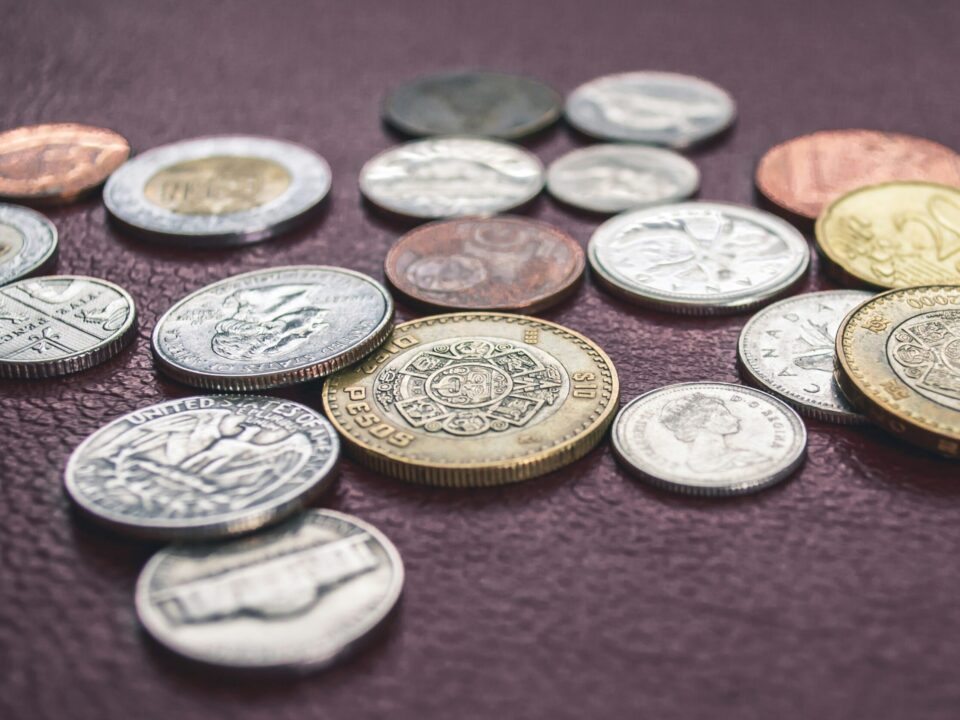 A photo of various coins, aimed at depicting the title of the blog post: "How much will it cost to translate my patent?"